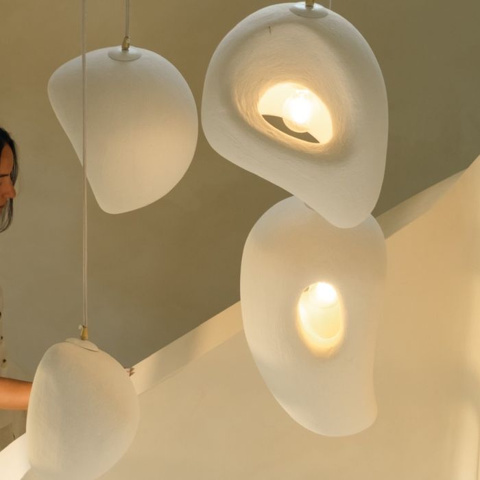 Woven pendant lights glowing in a quiet room